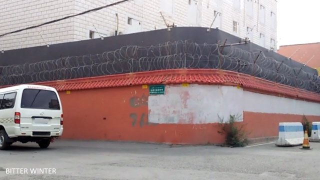 Building’s outer wall with two layers of barbed wire and high definition surveillance cameras